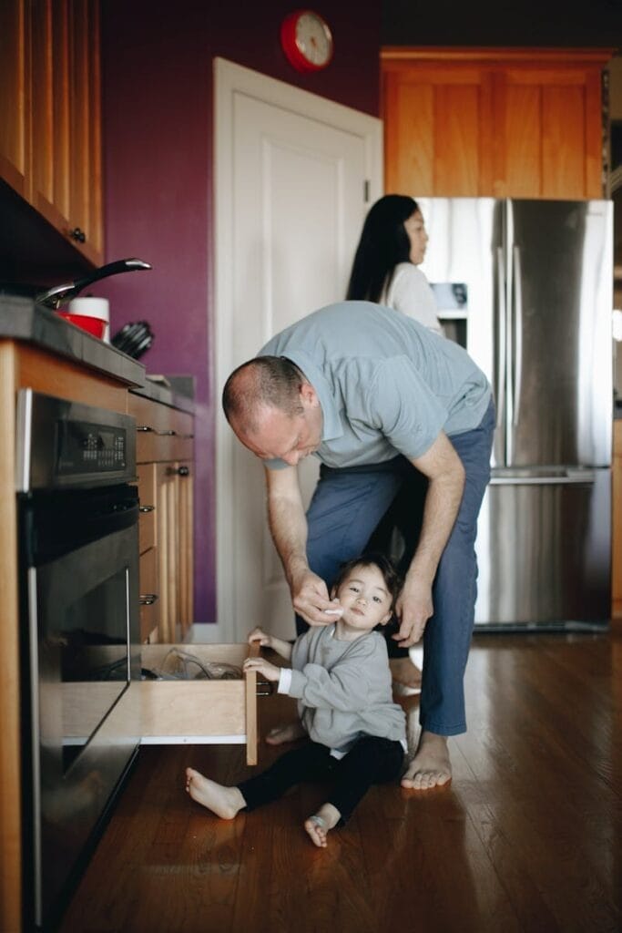 Father Wiping His Daughter's Face With Tissue with baby wipes