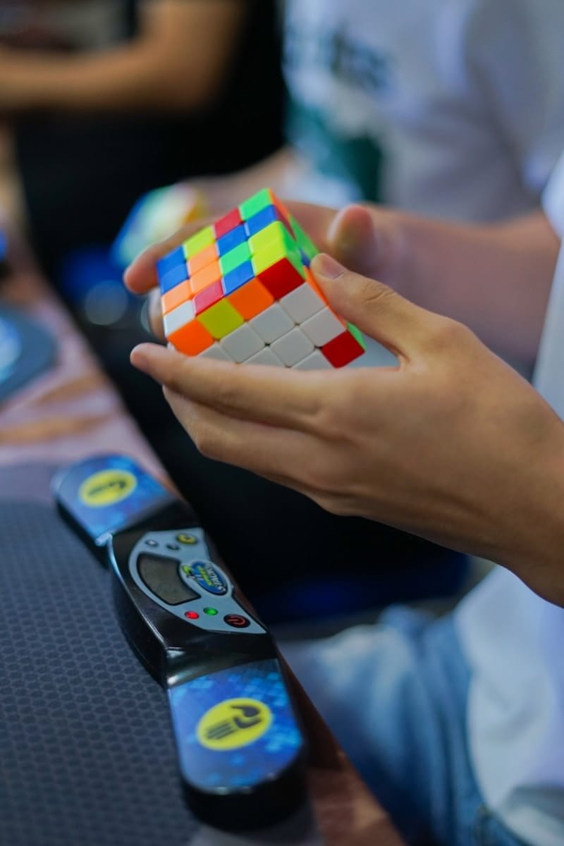 person holding 4 x 4 speed cube