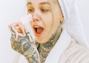 Skincare routine with a pore strip in a cozy robe and towel wrap