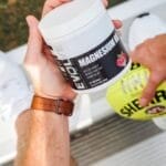 a man holding a jar of The best magnesium supplement