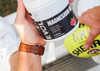 a man holding a jar of The best magnesium supplement